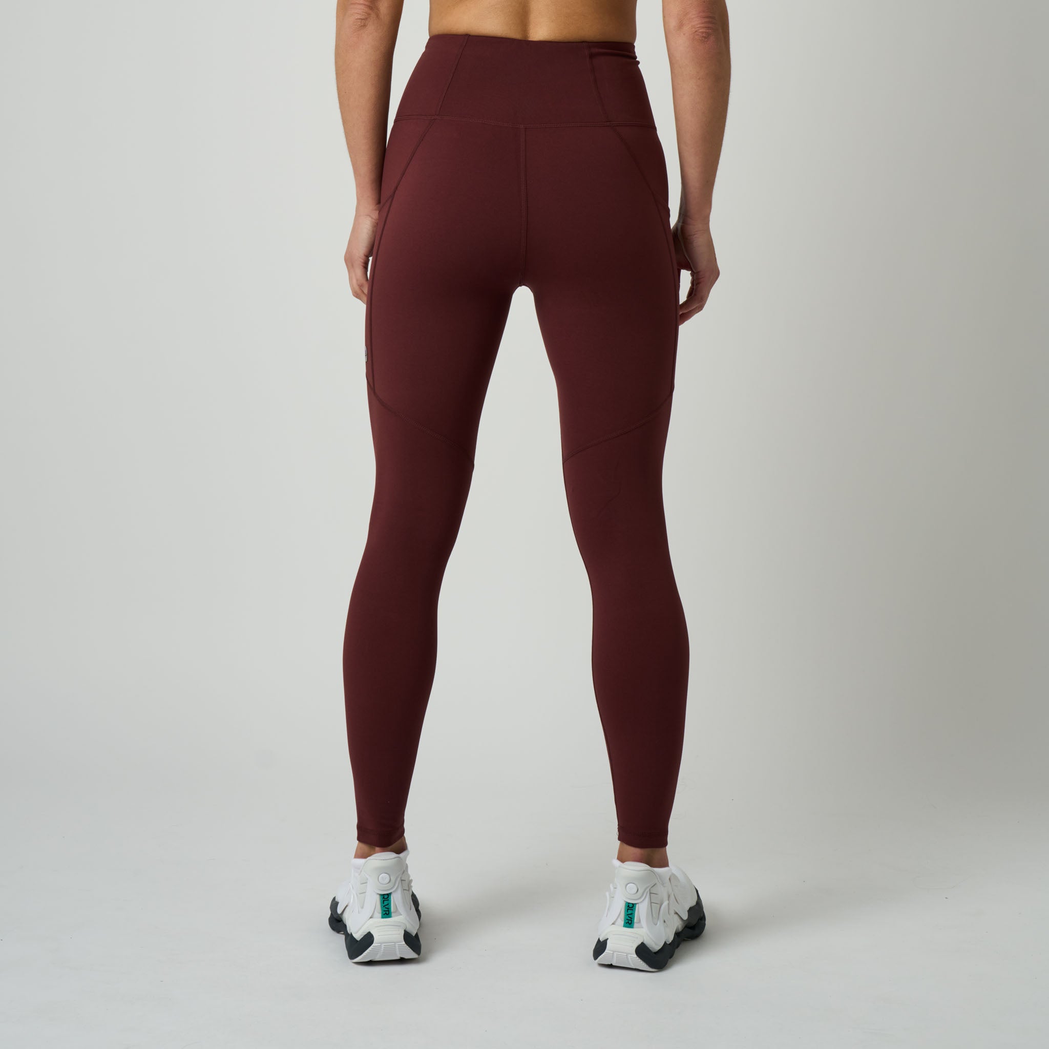 Maroon leggings worn by a person on a plain background