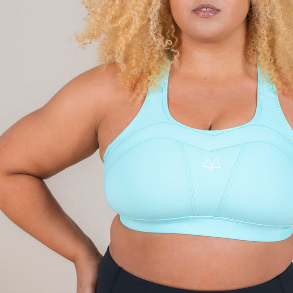Strong woman wearing MAAREE Empower Sports Bra in Spearmint Green colour