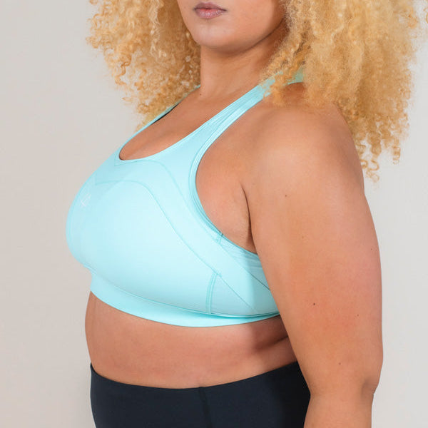 Woman standing side on wearing MAAREE Empower Sports Bra in Spearmint Green colour