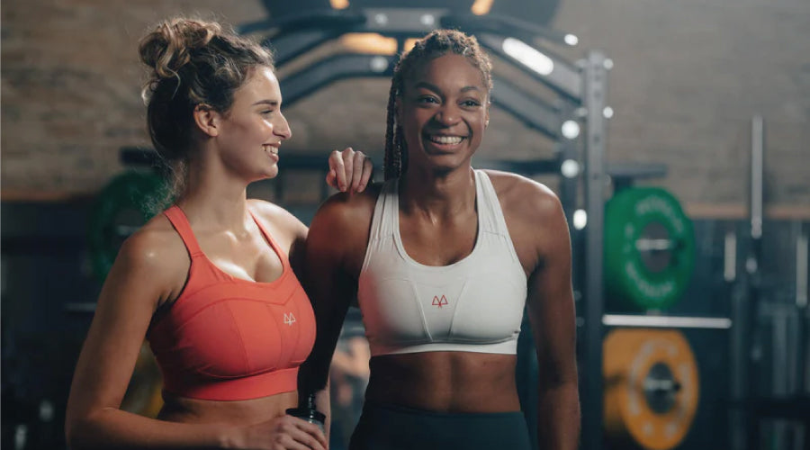 Two girls wearing maaree sports bras enjoying themselves in a gym